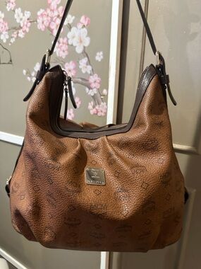 MCM Aren hobo bag made of cognac Visetos coated canvas with brown leather trim.